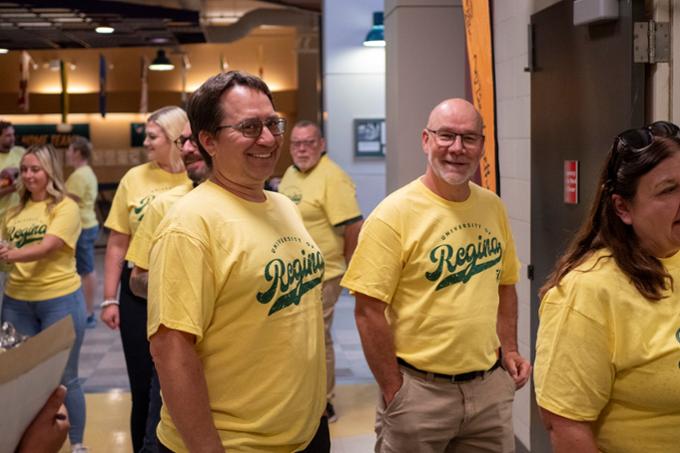 people stand in a line and smile for a photo