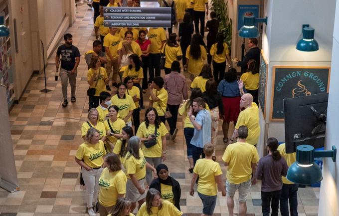 People in yellow shirts lined up