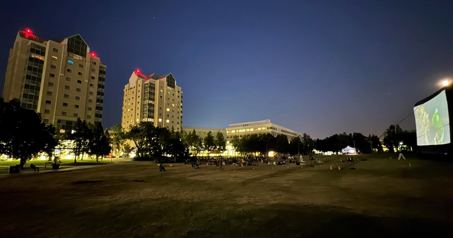 view of the Dr. Lloyd Barber Academic Green with a movie playing