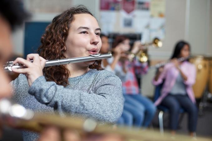 Group of young people learning instruments