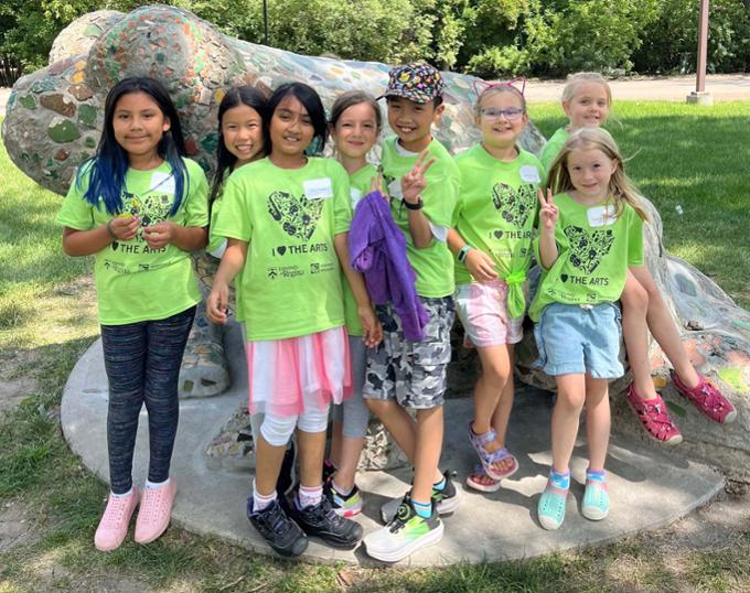 Kids pose at the frog statue