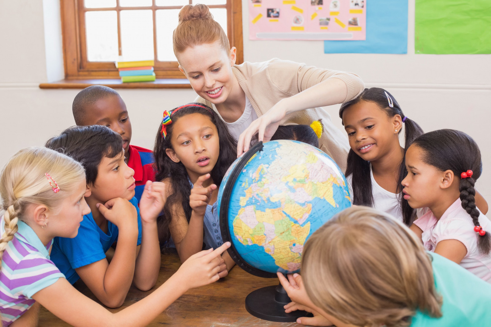 a teacher with students in a classroom