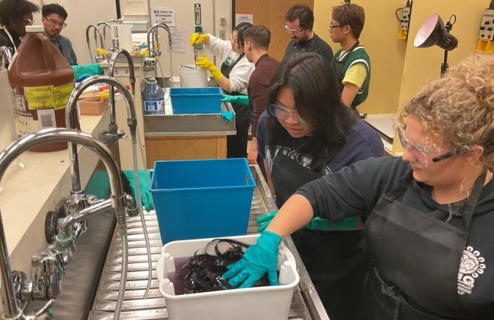 Students processing film in a lab