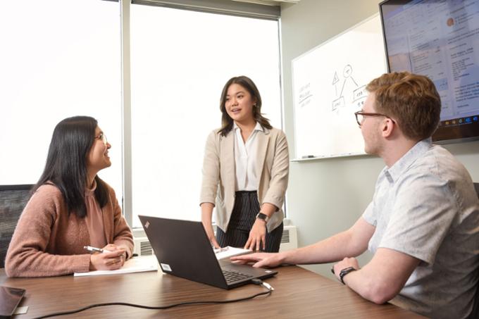 Three people discuss business