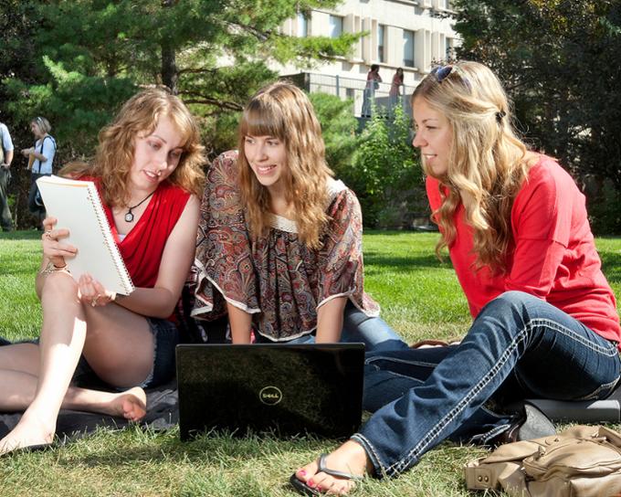 Students sitting on the academic green