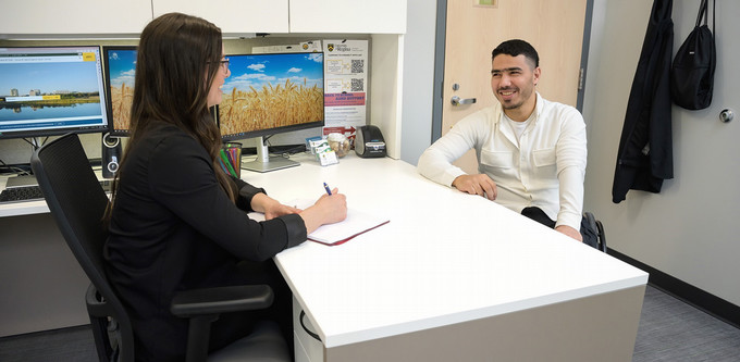 2 people sitting in an office