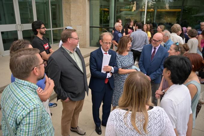 Large group of people mingling outdoors.