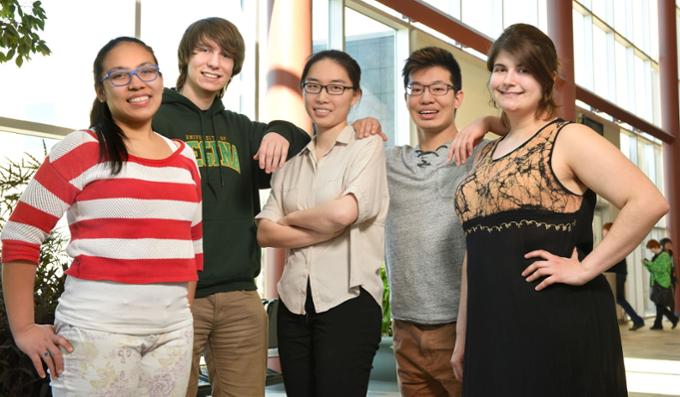 Five students stand next to each other.