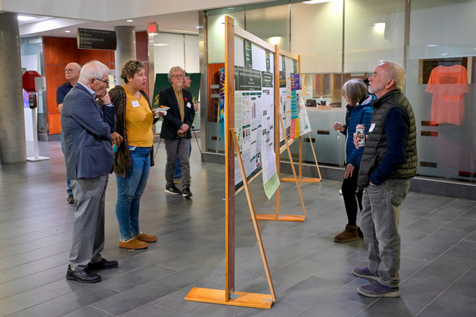 Group of people standing and reading posters