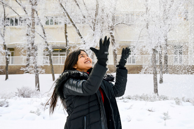 student throwing snow