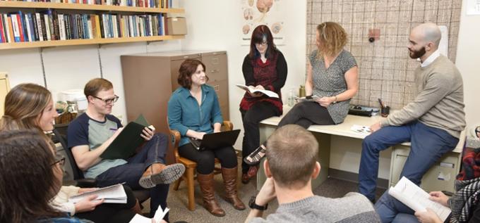 A group of students discussing Psychology with their professor.