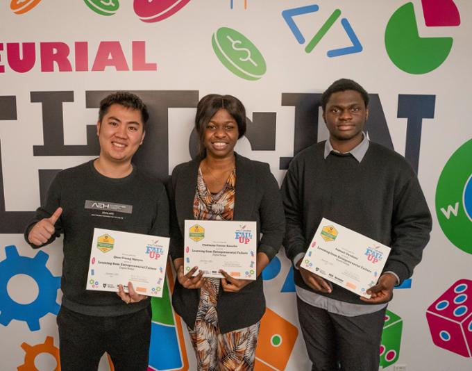 Three participants pose for a picture with their Fail UP certificates.