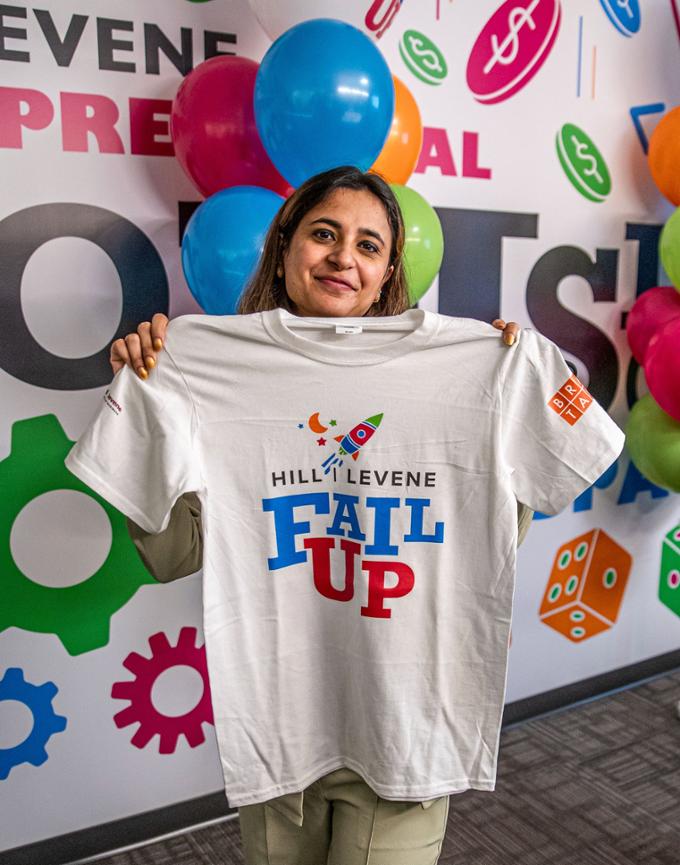 A participant holds up a Fail UP t-shirt.