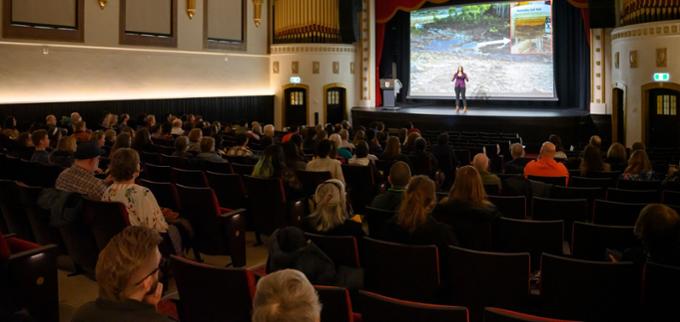 people sitting and watching a seminar