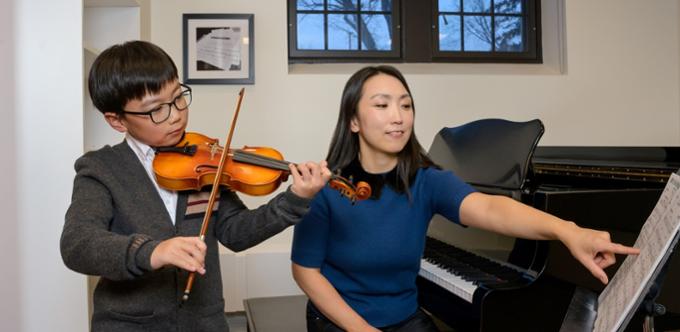 Young violin student with instructor