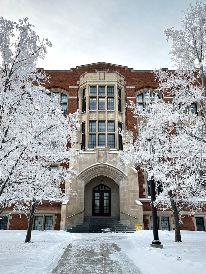 Frost-covered trees in front of the College Building in winter 2024.