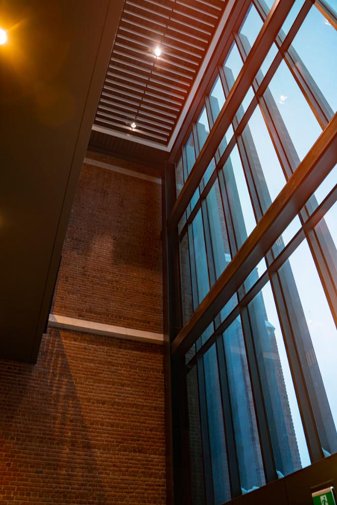 An upward angle of the south foyer at College Avenue Campus with light shining through the windows.