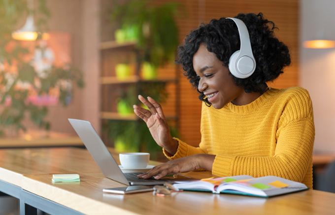 Student using a laptop with earphones on her head