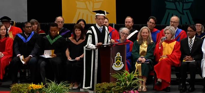 Professors sitting on stage at convocation ceremony
