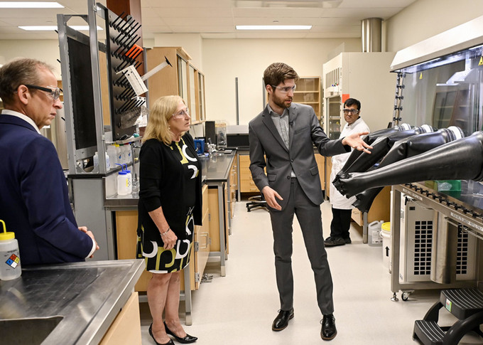 explaining the molten salt glove box in his Small Modular Reactors (SMRs) Fuel Corrosion Laboratory. (Photo courtesy of Innovation Saskatchewan)