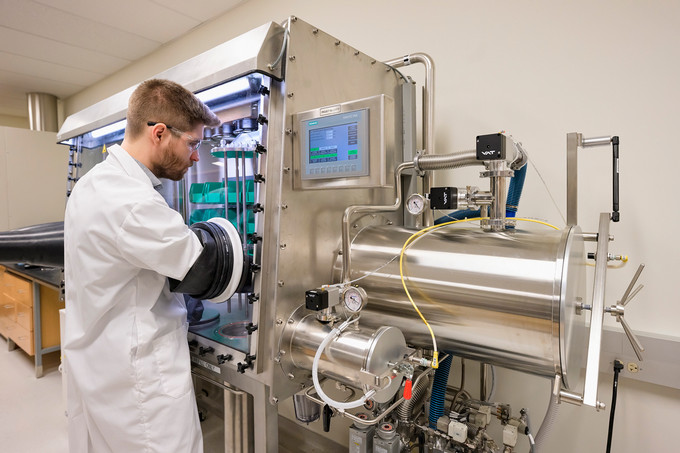 Dr. Arthur Situm working at the molten salt glove box used to handle radioactive materials. (Photo by Trevor Hopkin)