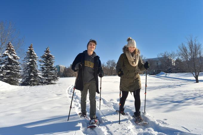 two students cross-country skiing