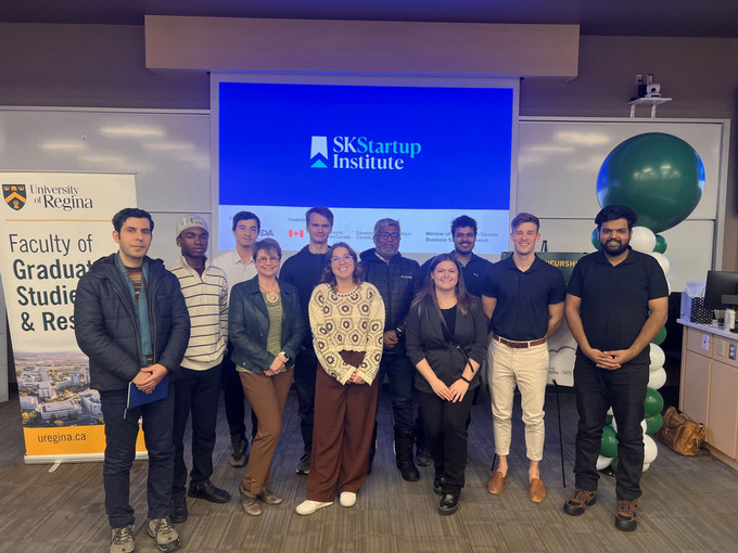 Participants standing in front of Sk Startup Institute Screen