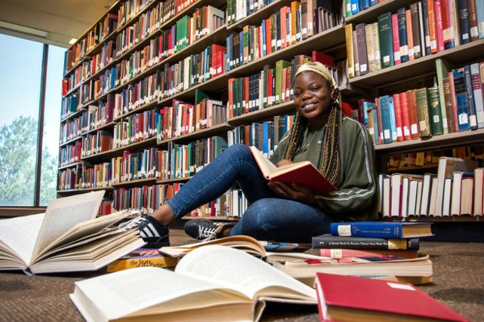 a student in a library with books