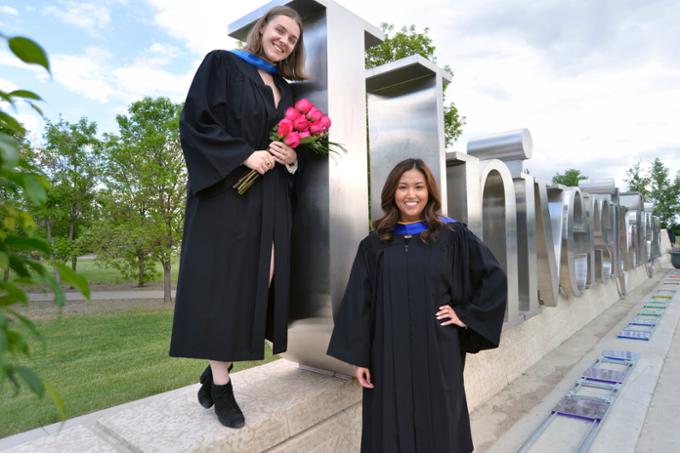 Students standing near U of R Sign