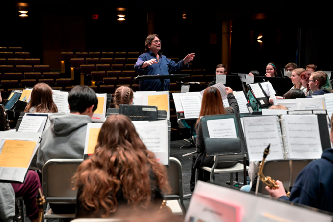 The school choir being led by a faculty member in performance