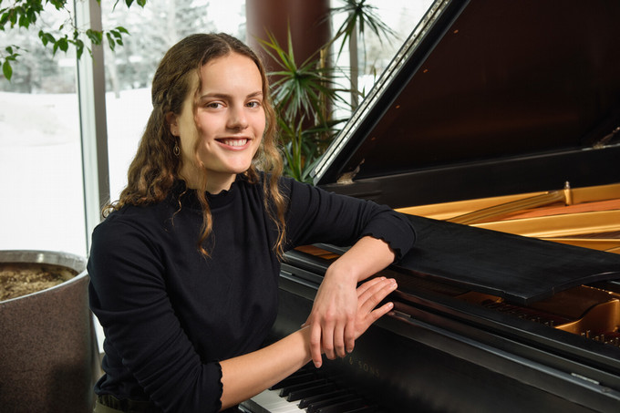 student with a piano