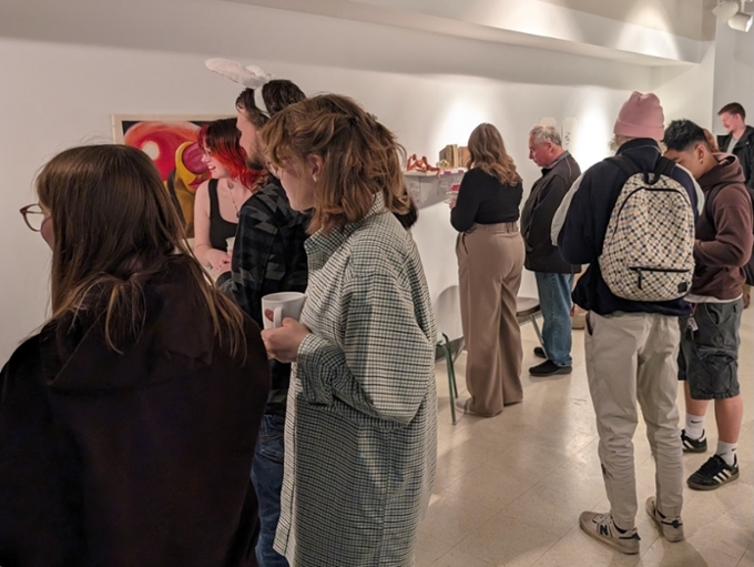 Students viewing the Painted Roses Exhibit in the Corner Gallery