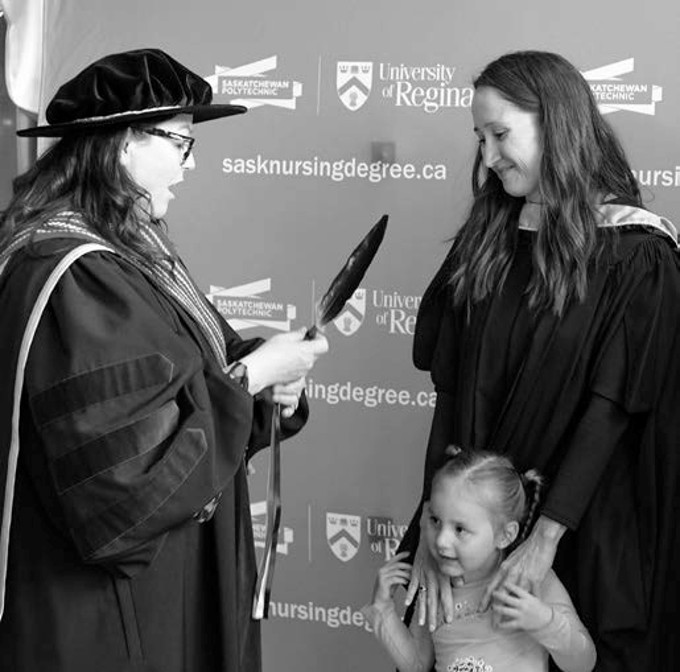 nursing graduate receiving an eagle feather