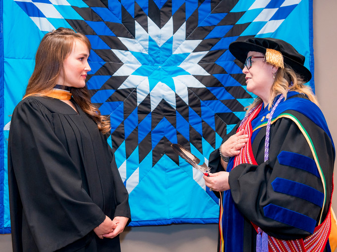 nursing graduate receiving eagle feather