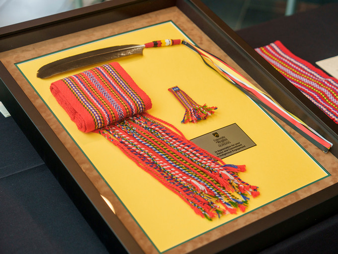 image of a metis sash and eagle feather