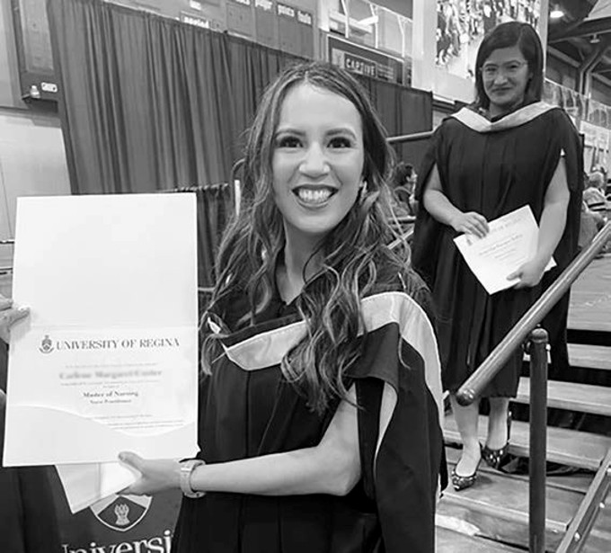 nursing graduate smiling and showing  degree