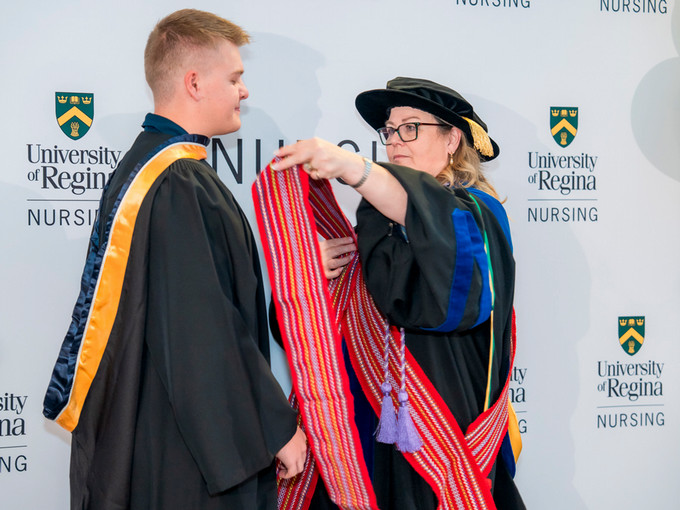 nursing student receiving metis sash at graduation 