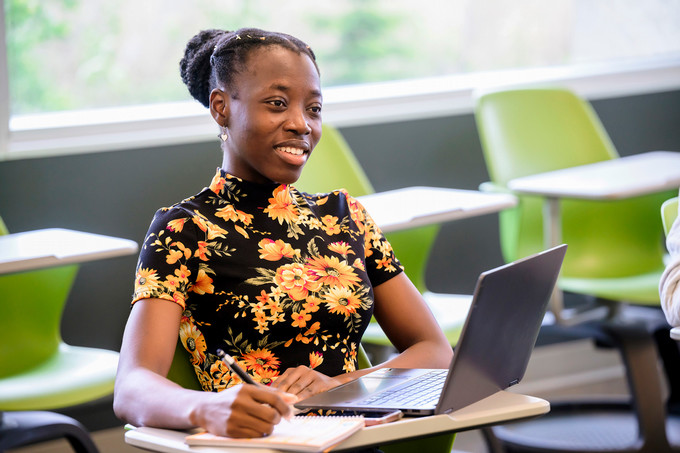 student sitting at a desk in a classroom