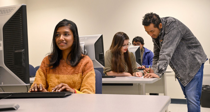 students in a classroom using desktop computers