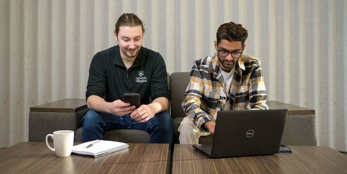 Two Students Sitting with a Laptop