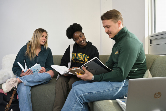 three students studying together