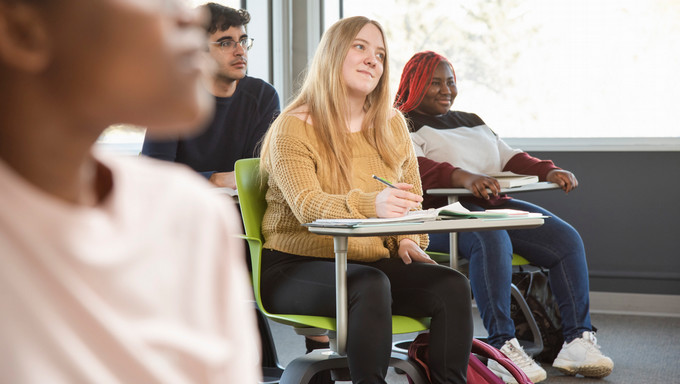 students sitting in desks in a classroom