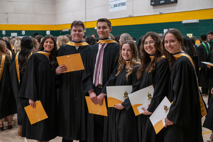 a large group of students at convocation in their gowns