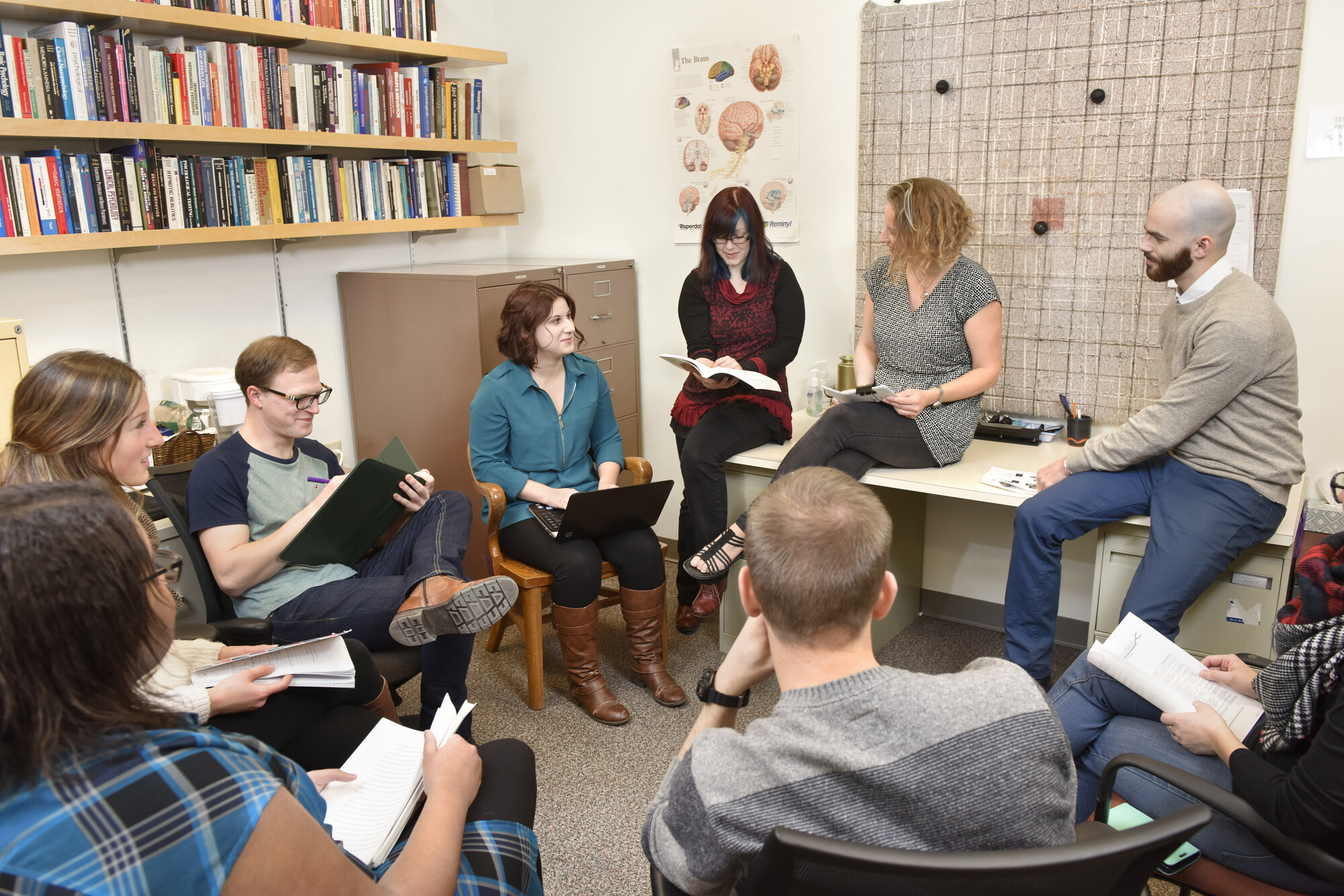 a group of people discussing research