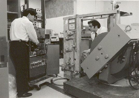 1971 photo of the NMR spectrophotometer, with graduate student Thian Ng (left), and Dr. E. Tward (right).