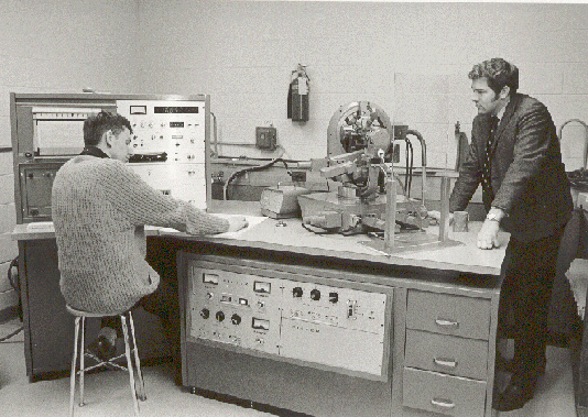 1975 photo of the X-ray diffractometer, with undergraduate assistant John Marley (left), and Dr. Bev Robertson (right).