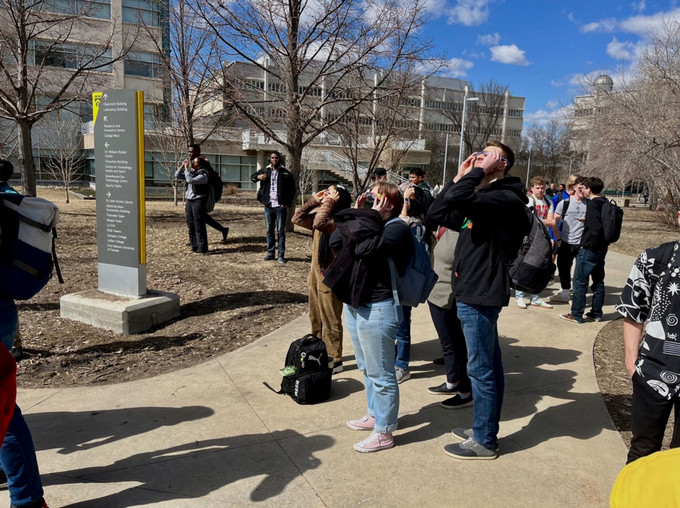 students looking at an eclipse