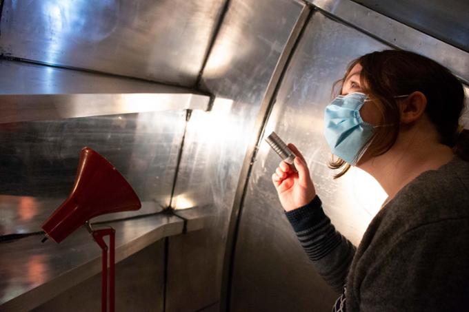 Student inspecting a detector. 