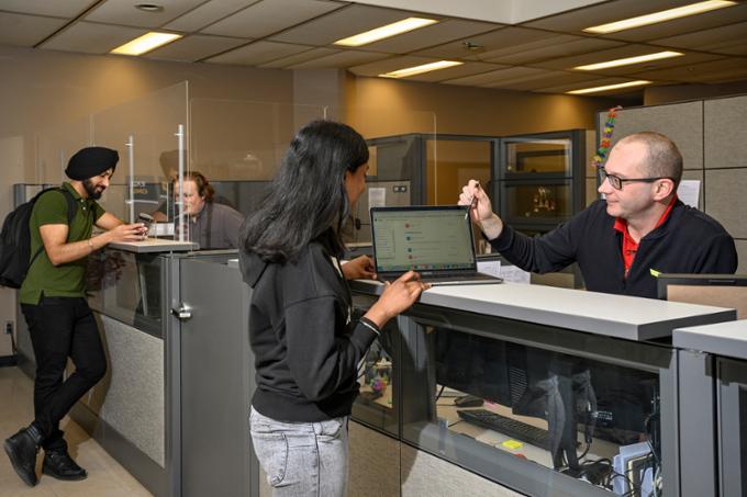 student getting help from the service desk