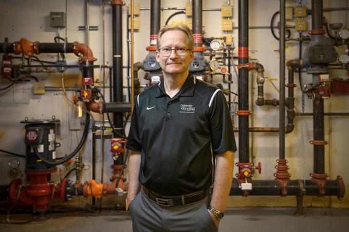 Rob Kleisinger, winner of the Board of Governors Distinguished Service Award, is standing in an equipment room below the University of Regina.